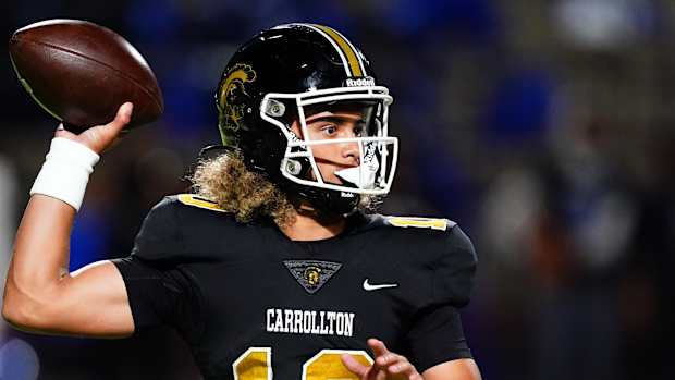 Oct 20, 2023; Carrollton, GA, USA; Carrollton Trojans quarterback Julian Lewis (10) drops back to pass against the Westlake Lions during the first half at Grisham Stadium. The 15-year-old Carrollton High student has already committed to playing for the University of Southern California Trojans and has been considered one of the top high school quarterback prospects. 